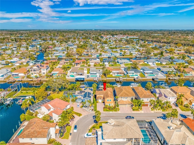 drone / aerial view with a residential view and a water view