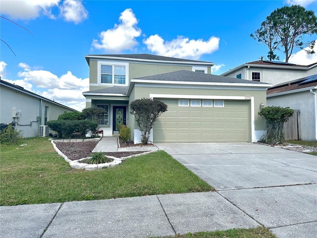 traditional-style house with a garage, a front yard, driveway, and stucco siding