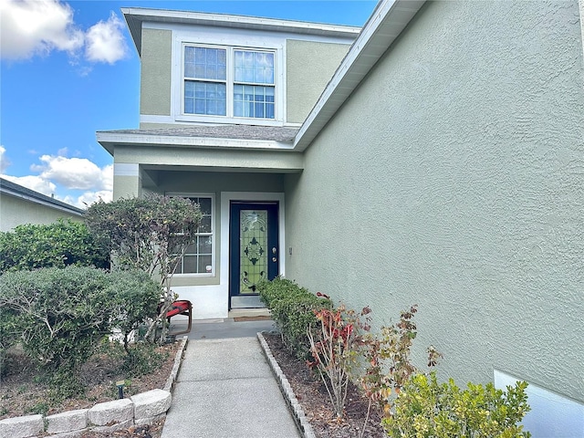 property entrance with stucco siding