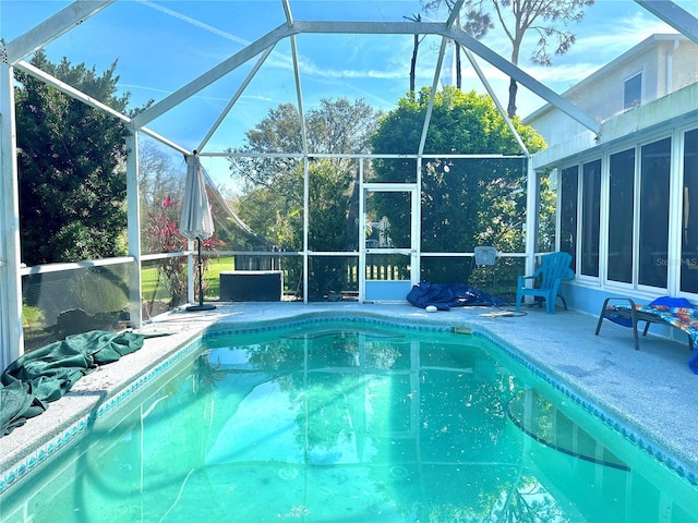 pool with a lanai and a patio area