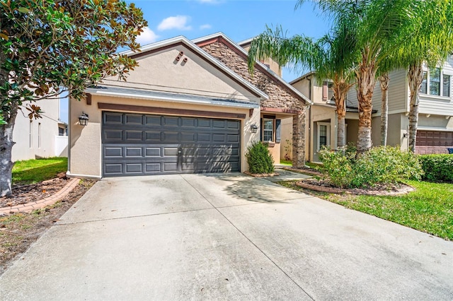 view of front of house featuring an attached garage, concrete driveway, and stucco siding