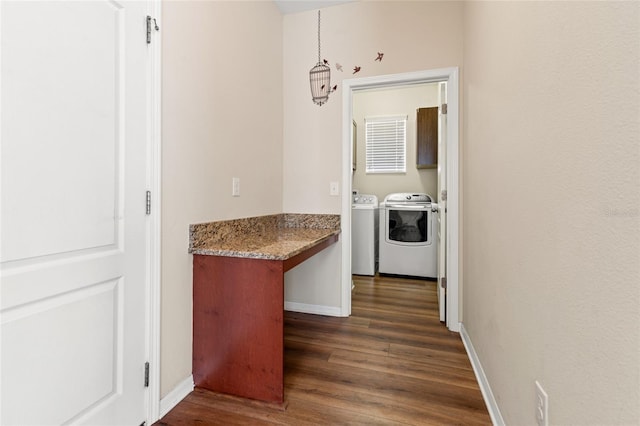 interior space featuring dark wood-type flooring, washer and clothes dryer, and baseboards