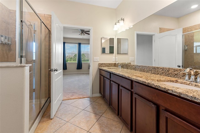 full bathroom with tile patterned flooring, a sink, and a shower stall