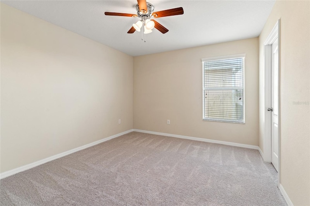 empty room with light carpet, a ceiling fan, and baseboards