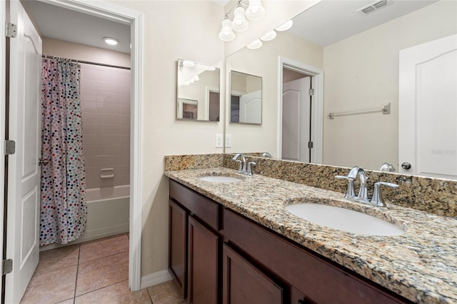 full bathroom featuring double vanity, visible vents, a sink, and tile patterned floors