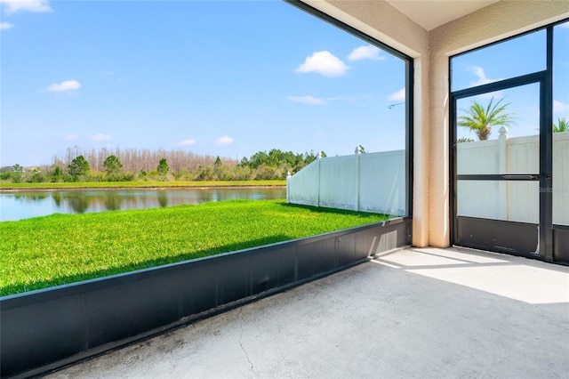 unfurnished sunroom with a water view