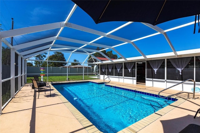 view of swimming pool featuring a lanai and a patio