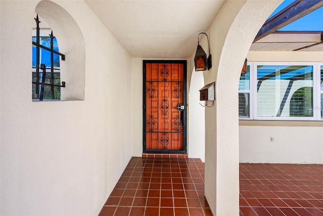 property entrance with stucco siding