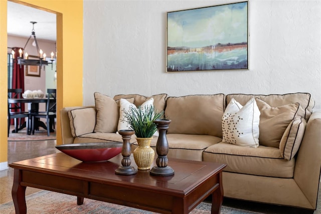 living area with a chandelier and a textured wall