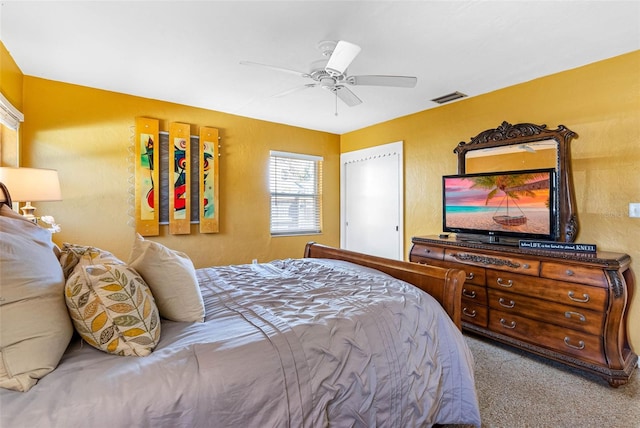 bedroom featuring light carpet, visible vents, and a ceiling fan