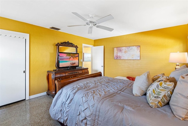 bedroom featuring light speckled floor, visible vents, ceiling fan, and baseboards