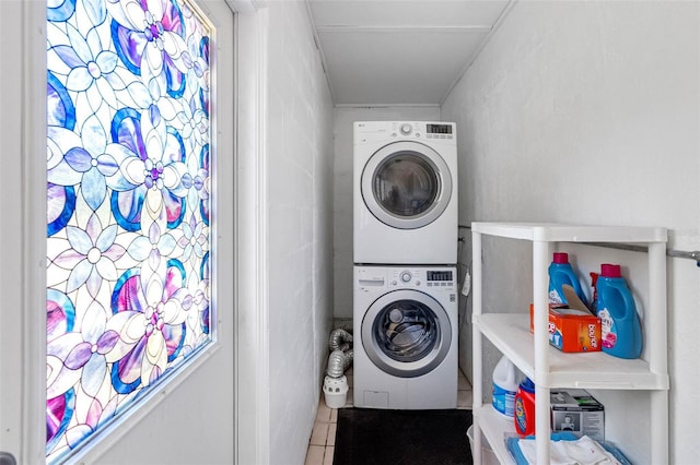 washroom with laundry area, stacked washer / dryer, and tile patterned floors