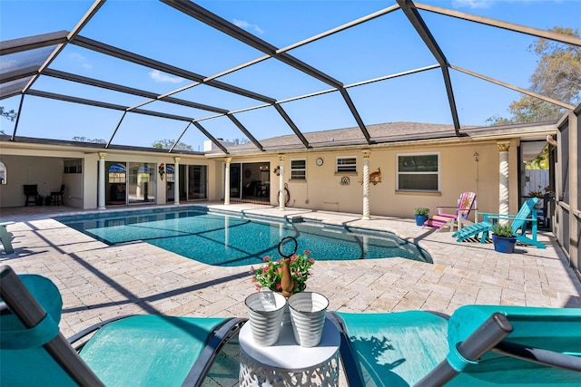 outdoor pool featuring a patio area and glass enclosure