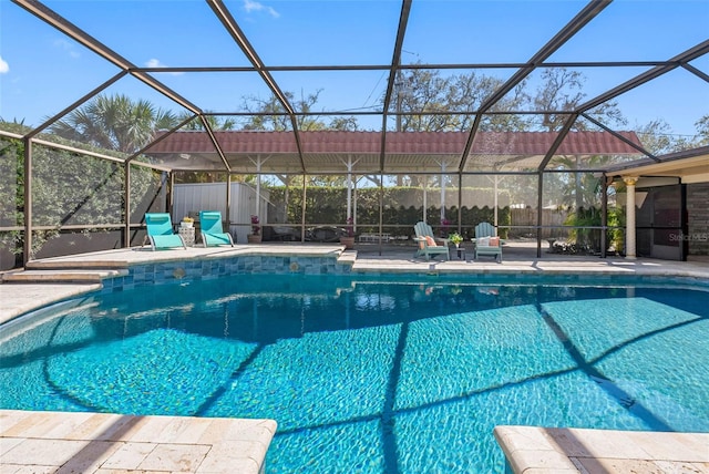 pool with glass enclosure and a patio area