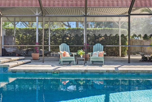 view of pool with a fenced in pool, a lanai, fence, and a patio