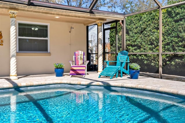 outdoor pool with a lanai and a patio area