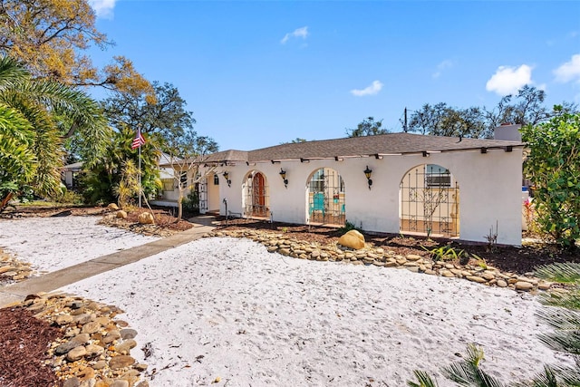 mediterranean / spanish-style house featuring french doors and stucco siding