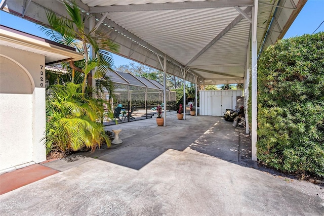 view of patio with a lanai and a gate