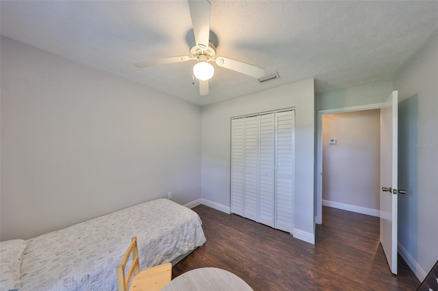 bedroom featuring a closet, visible vents, baseboards, and wood finished floors