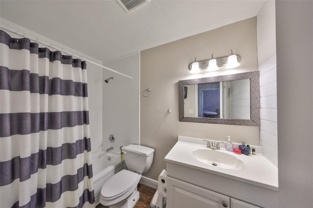 bathroom featuring shower / bath combination with curtain, visible vents, toilet, vanity, and a textured ceiling