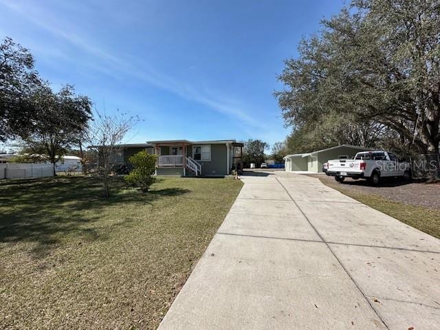 view of front of house featuring a front yard and concrete driveway