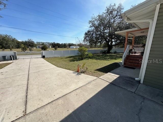 view of yard featuring fence and a patio