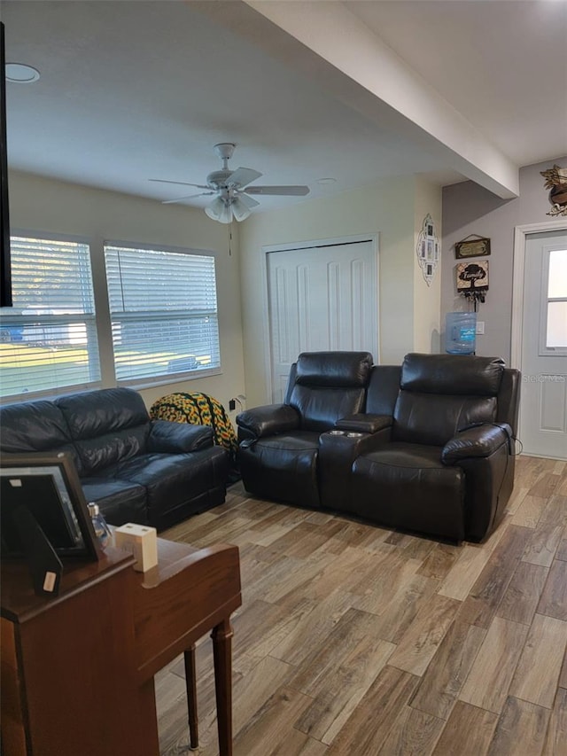 living area with light wood-style floors and ceiling fan