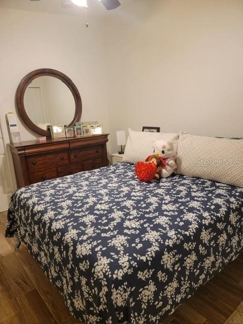 bedroom featuring ceiling fan and wood finished floors