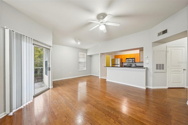 unfurnished living room featuring hardwood / wood-style flooring, visible vents, and a ceiling fan