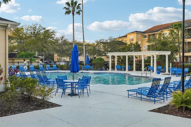 pool featuring a patio area, fence, and a pergola