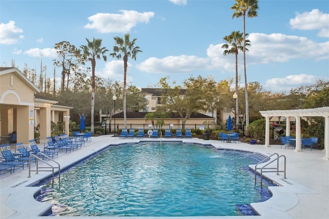 pool with fence, a patio, and a pergola