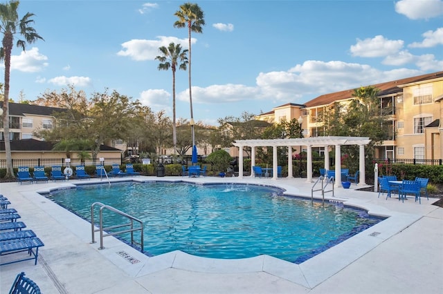 community pool with fence, a patio, and a pergola