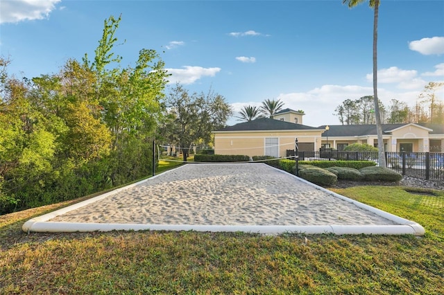 view of property's community with volleyball court and fence