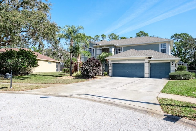 traditional home with a garage, driveway, a front lawn, and stucco siding