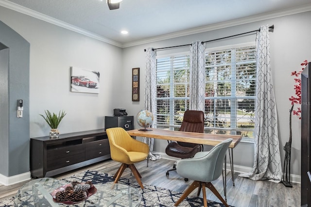 office space featuring baseboards, ornamental molding, and wood finished floors