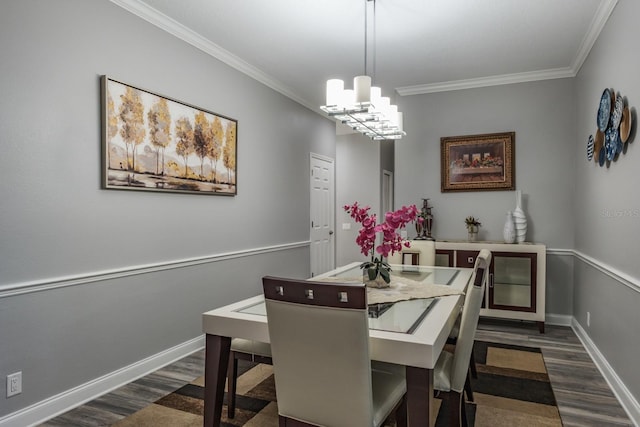 dining space with baseboards, a chandelier, dark wood-type flooring, and crown molding