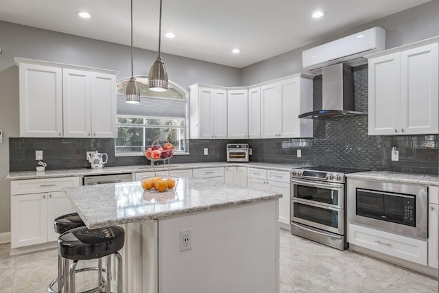 kitchen featuring a kitchen island, appliances with stainless steel finishes, and white cabinets