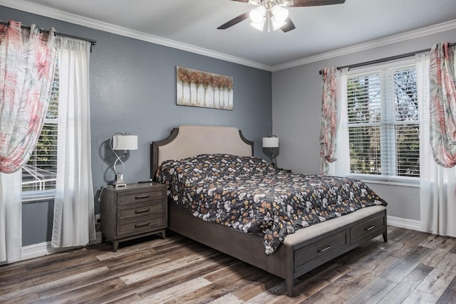 bedroom featuring a ceiling fan, crown molding, baseboards, and wood finished floors