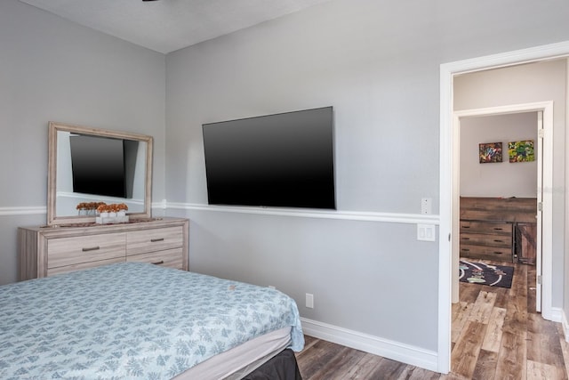 bedroom featuring baseboards and wood finished floors