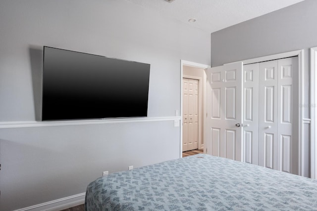 bedroom with a closet and baseboards