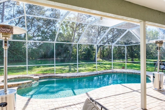 view of swimming pool with a yard, a patio area, glass enclosure, and a pool with connected hot tub