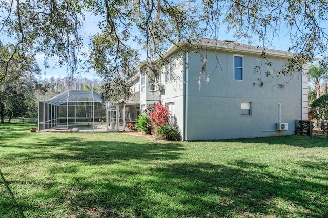 exterior space with a yard, a lanai, and an outdoor pool