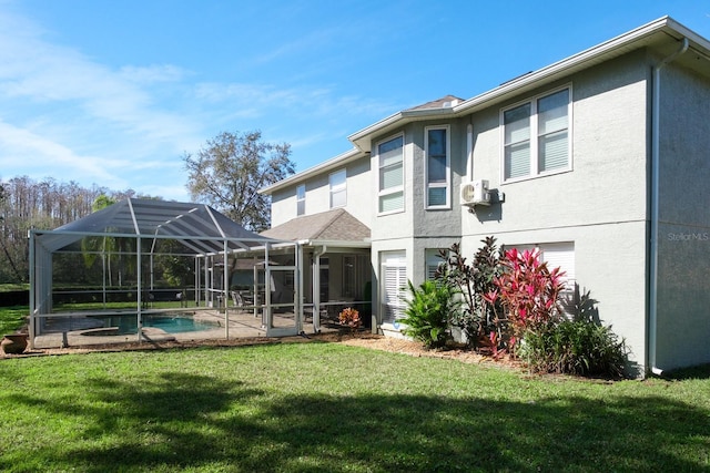 rear view of property with a yard, a patio, stucco siding, glass enclosure, and an outdoor pool