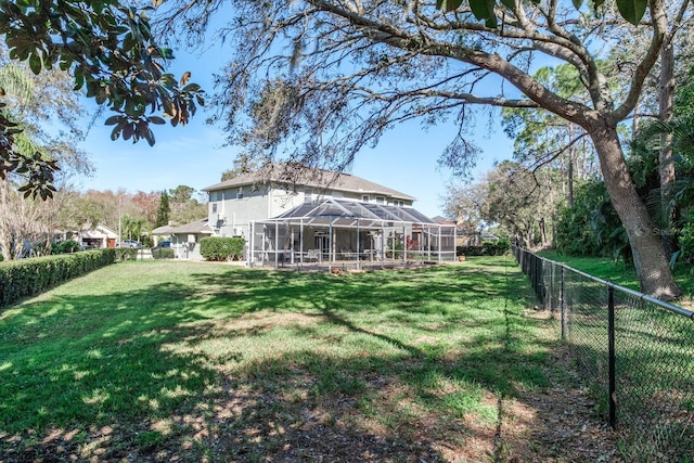 view of yard with glass enclosure and a fenced backyard