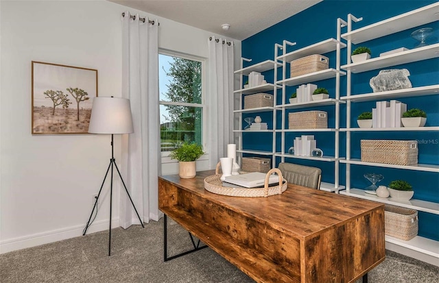 carpeted home office featuring baseboards