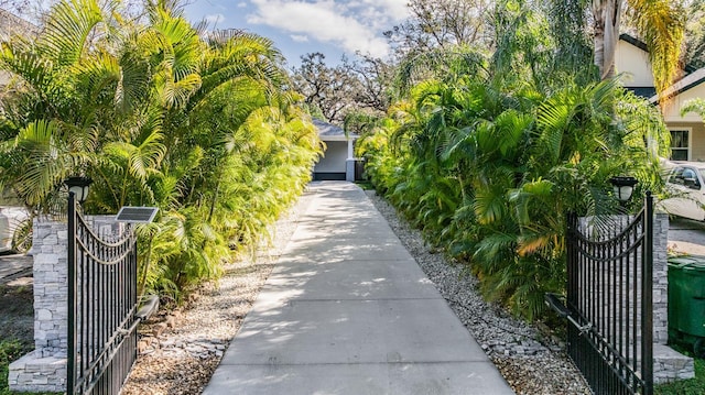 exterior space with driveway and a gate