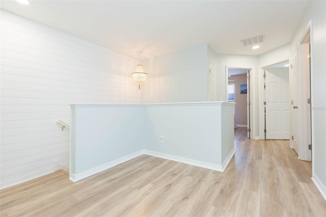 unfurnished room featuring light wood-style floors, baseboards, visible vents, and recessed lighting