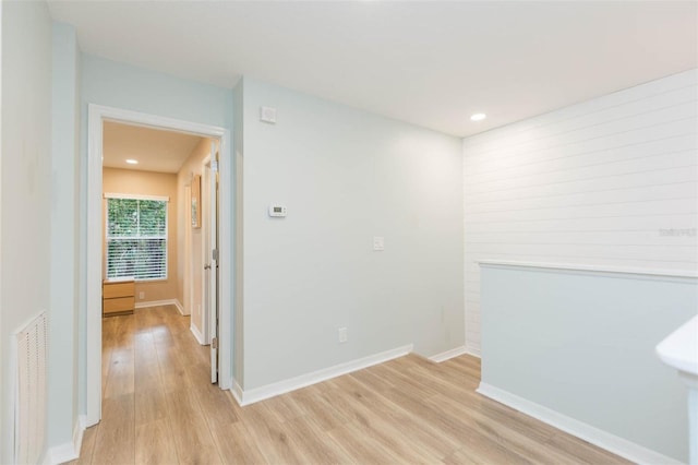 interior space featuring baseboards, visible vents, and light wood finished floors