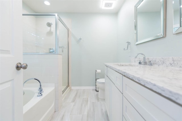 bathroom with a garden tub, toilet, vanity, baseboards, and a shower stall