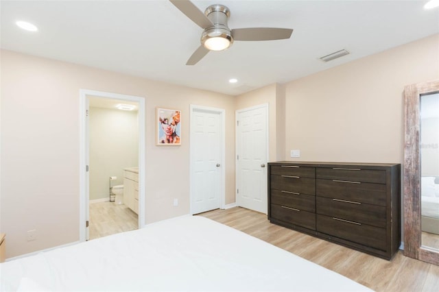 bedroom featuring light wood-type flooring, connected bathroom, and recessed lighting